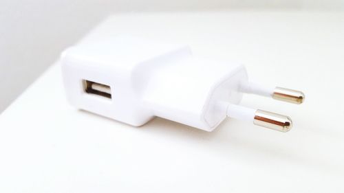 Close-up of mobile phone charger on table