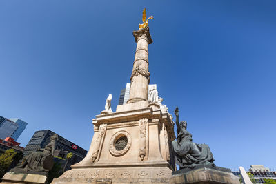 Low angle view of statue against blue sky