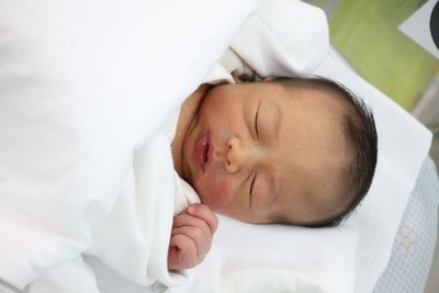 Cute baby sleeping on bed