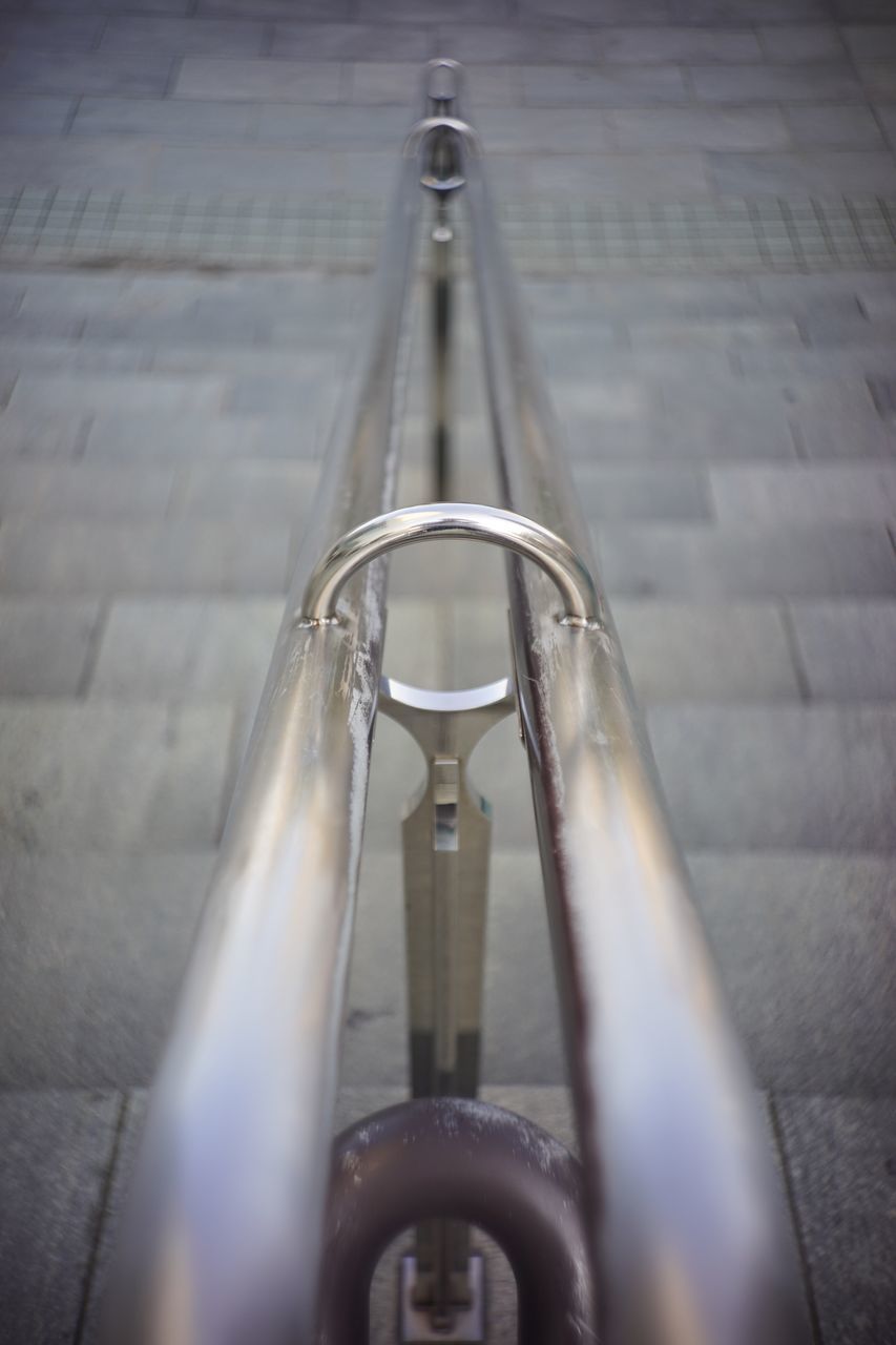 metal, indoors, close-up, metallic, still life, no people, focus on foreground, industry, shiny, steel, high angle view, sunlight, day, pipe - tube, absence, empty, railing, reflection, equipment, single object