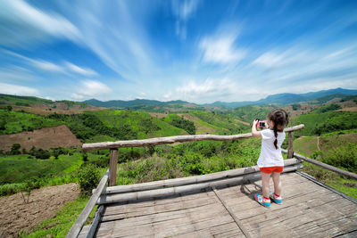 Rear view of people standing on landscape