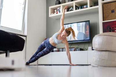 Woman with arms outstretched at home