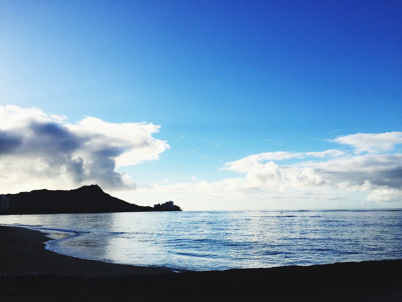 sea, water, tranquil scene, scenics, sky, tranquility, blue, beauty in nature, horizon over water, nature, idyllic, cloud, calm, shore, cloud - sky, outdoors, remote, coastline, seascape, ocean, non-urban scene, no people, rippled, mountain, day, non urban scene, majestic