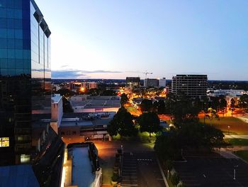 View of city lit up against sky