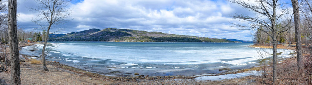 Scenic view of lake against sky during winter