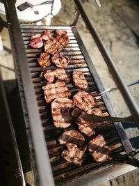 High angle view of meat on barbecue grill