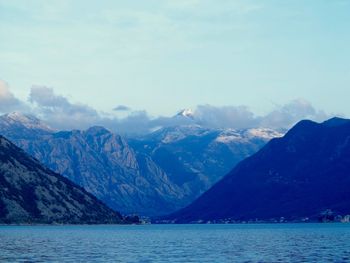 Scenic view of lake and mountains against sky