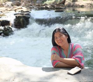 Portrait of woman sitting in water