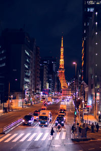 Traffic on city street and buildings at night