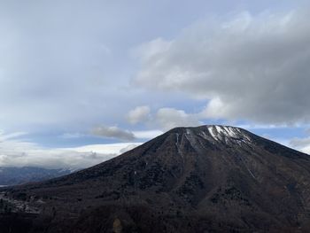 Scenic view of volcanic mountain against sky