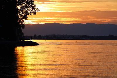 Scenic view of sea against orange sky