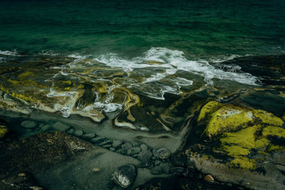 High angle view of rocks at sea shore