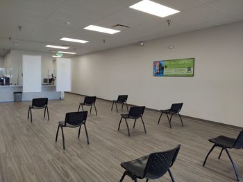 Empty chairs and tables in corridor