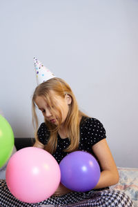 Children have fun playing, blowing up colorful balloons, at a birthday party