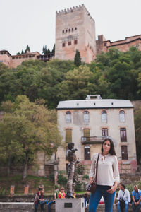 Woman standing by tree