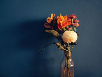 Close-up of wilted plant in vase against wall