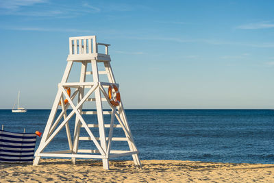 Lifeguard hut on beach against sky