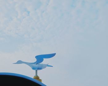 Low angle view of seagull flying against sky