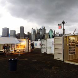 Buildings against cloudy sky