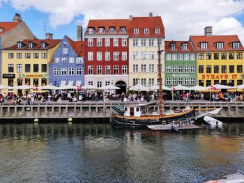 Buildings by canal in city