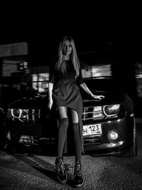 Portrait of young woman in car at night