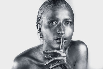 Portrait of young woman against white background