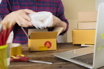 Midsection of man working at table