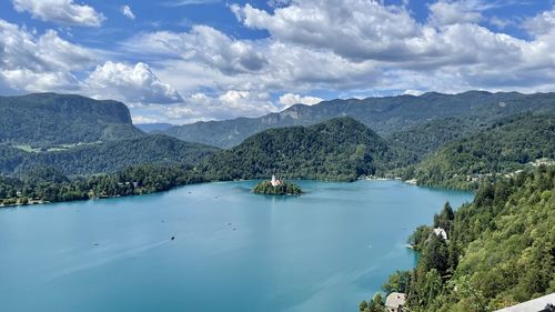 Scenic view of sea and mountains against sky