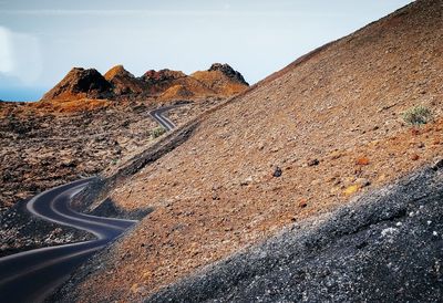 Scenic view of mountain road against sky