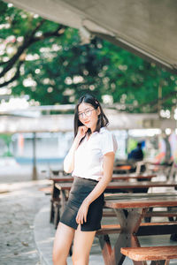 Portrait of a smiling young woman standing outdoors