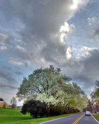 Country road against cloudy sky