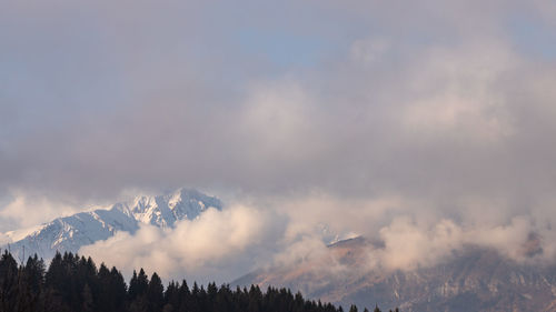 Low angle view of snowcapped mountains against sky