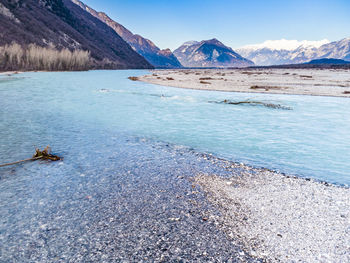 Scenic view of lake and mountains against sky