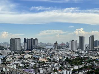 High angle view of modern buildings in city against sky