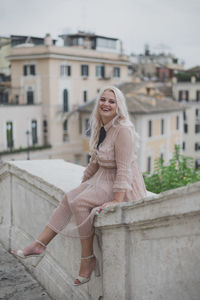 Portrait of a smiling young woman in city