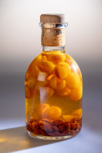 Close-up of juice in glass on table against wall