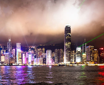 Illuminated buildings against sky at night