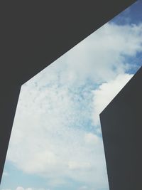Low angle view of building against cloudy sky