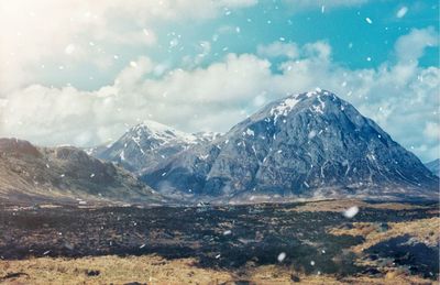 Scenic view of snowcapped mountains against sky