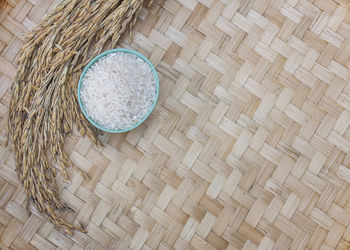 High angle view of rice and wheat on wicker table