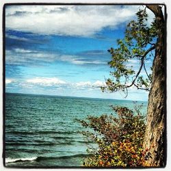 Scenic view of sea against cloudy sky