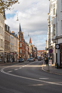 City street and buildings against sky