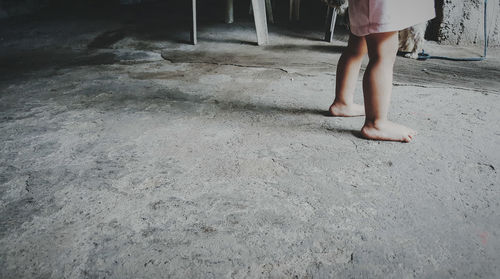 Low section of woman standing on ground