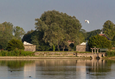 Scenic view of lake by building against sky