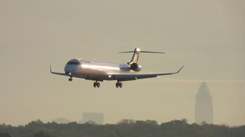 Low angle view of airplane flying against clear sky