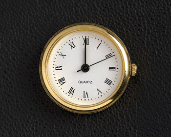 Close-up of clock on table