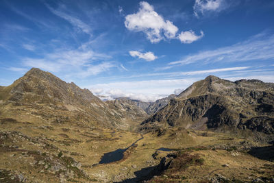 Scenic view of mountains against blue sky