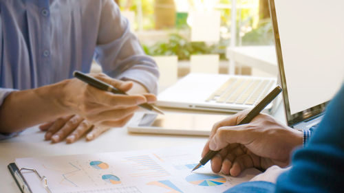 Midsection of woman working at table in office