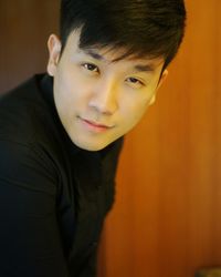 Close-up portrait of handsome man standing at home