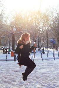 Woman playing with umbrella in winter